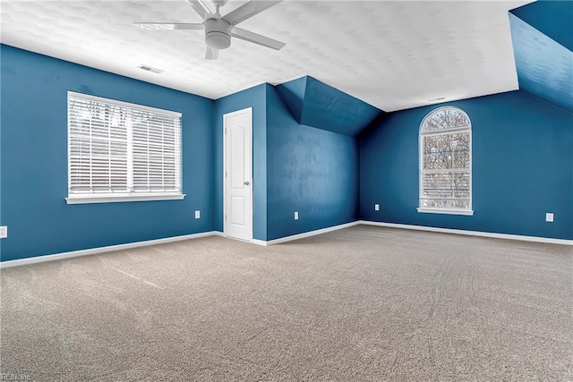 bonus room featuring visible vents, lofted ceiling, a ceiling fan, carpet flooring, and baseboards