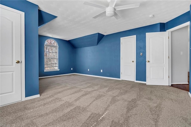 additional living space featuring baseboards, lofted ceiling, ceiling fan, and carpet flooring