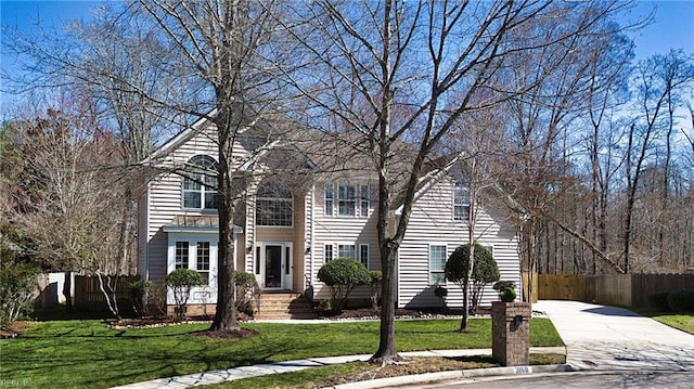 view of front of property with a front yard and fence