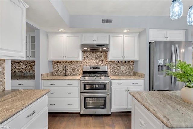 kitchen featuring under cabinet range hood, visible vents, appliances with stainless steel finishes, and dark wood finished floors