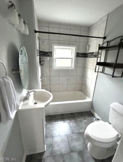 full bath featuring vanity, toilet, and washtub / shower combination