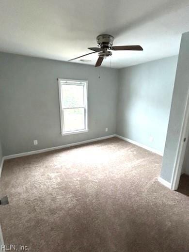 spare room featuring a ceiling fan, baseboards, and carpet floors