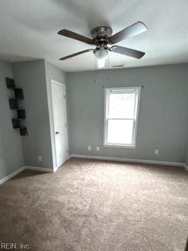 unfurnished room featuring ceiling fan, baseboards, and carpet