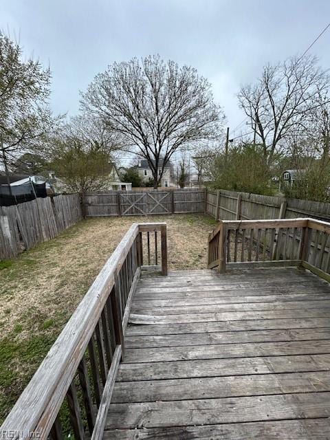 deck with a yard and a fenced backyard