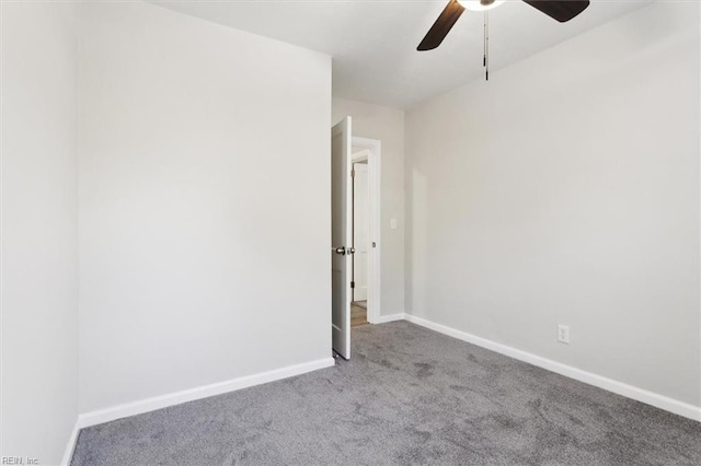 empty room with a ceiling fan, carpet, and baseboards