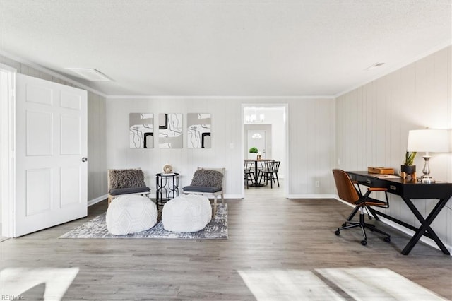 interior space featuring crown molding, wood finished floors, and baseboards