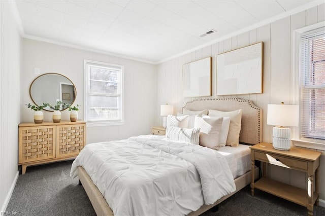 bedroom with crown molding, visible vents, and carpet floors