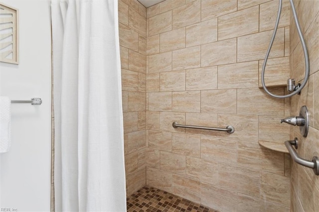 bathroom with tiled shower