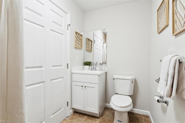 full bathroom with tile patterned flooring, toilet, vanity, and baseboards