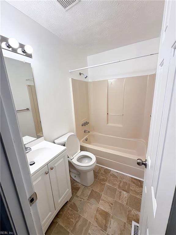 bathroom with vanity, visible vents, a textured ceiling, shower / bathing tub combination, and toilet