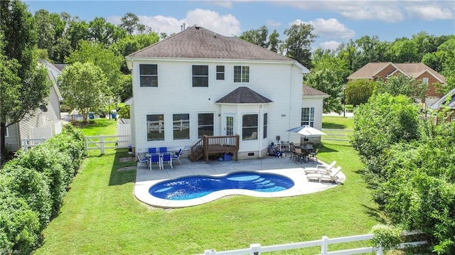 back of house with a patio area, a fenced backyard, a yard, and crawl space