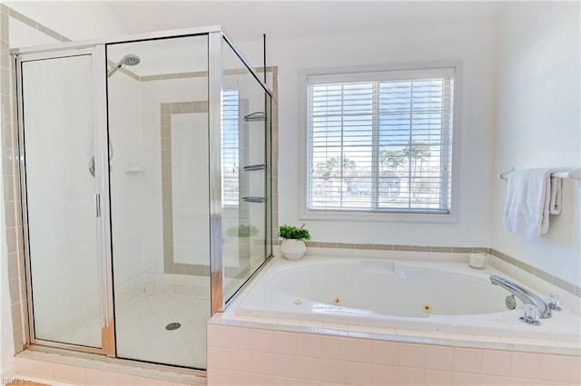 bathroom featuring a jetted tub and a stall shower