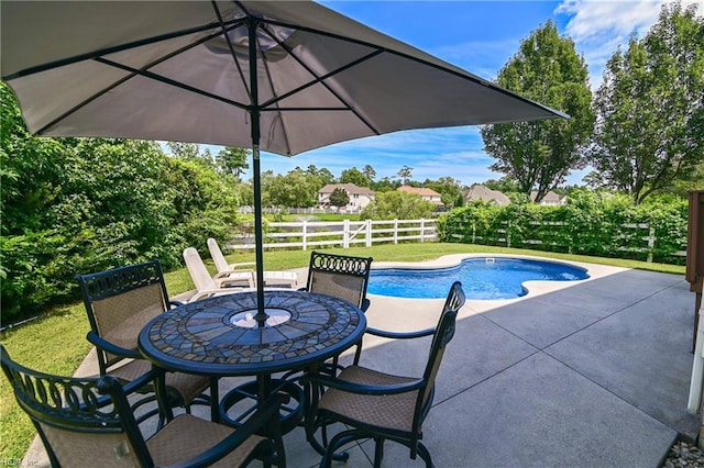 view of pool with a fenced in pool, fence, a yard, a patio area, and outdoor dining space