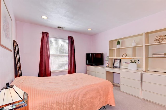 bedroom featuring built in study area, recessed lighting, visible vents, and light carpet