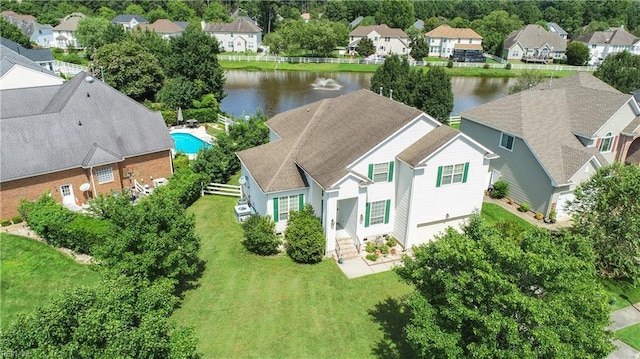 drone / aerial view featuring a residential view and a water view