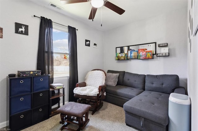 living room with a ceiling fan, visible vents, and carpet floors