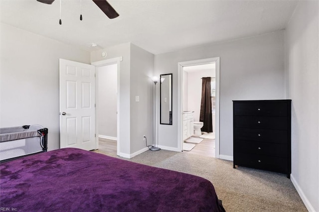 carpeted bedroom featuring baseboards, a ceiling fan, and ensuite bathroom