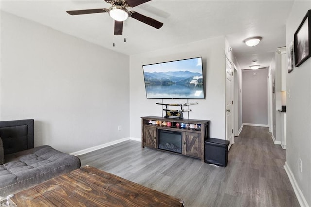 living room with baseboards and wood finished floors