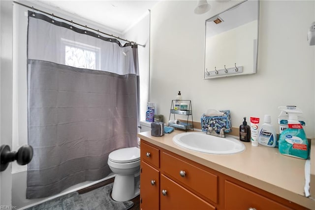 bathroom with vanity, curtained shower, and toilet