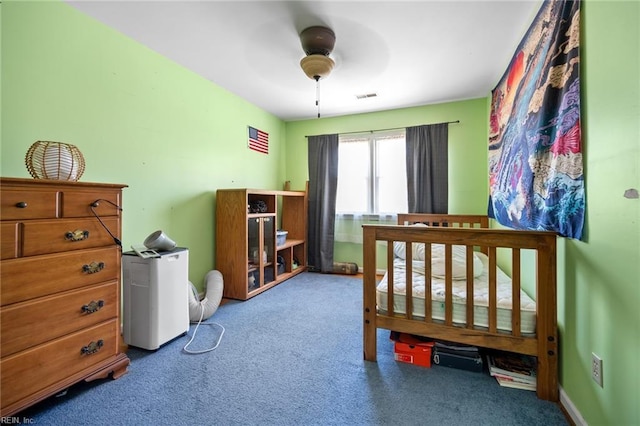 bedroom with visible vents, a ceiling fan, and carpet flooring