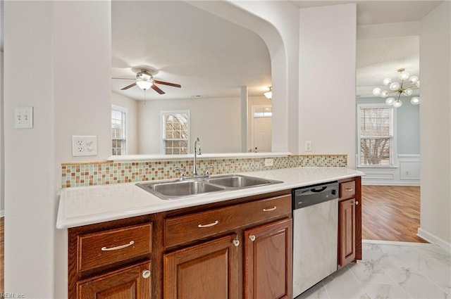 kitchen featuring a healthy amount of sunlight, dishwasher, light countertops, and a sink