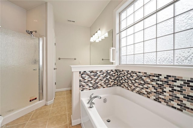 bathroom with tile patterned floors, visible vents, a stall shower, and a bath