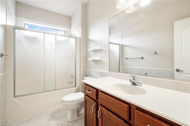 bathroom featuring bath / shower combo with glass door, toilet, marble finish floor, and vanity