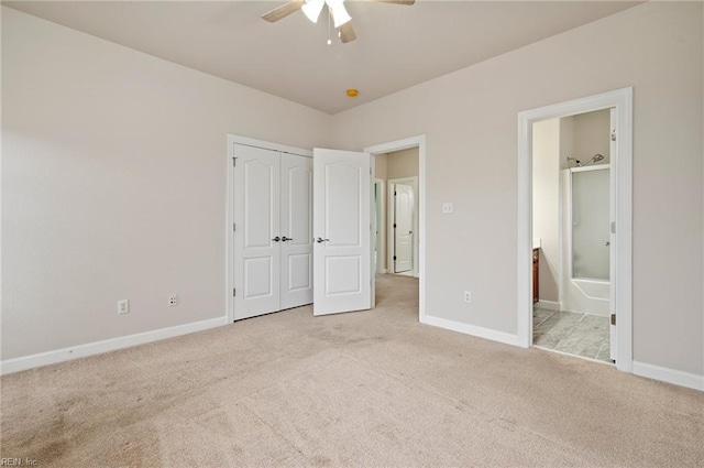 unfurnished bedroom featuring ensuite bath, baseboards, and carpet floors