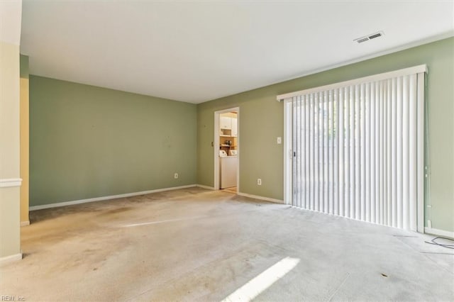 unfurnished living room featuring visible vents, baseboards, and carpet flooring