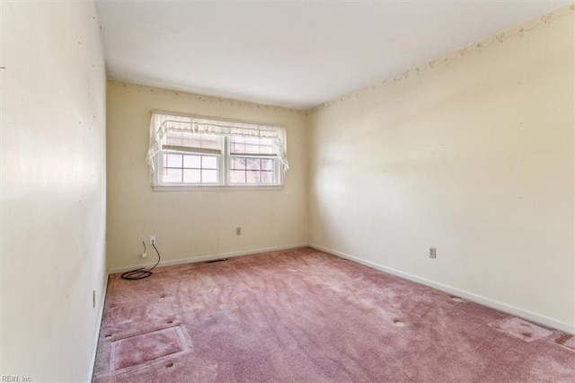 unfurnished room with visible vents, carpet floors, and baseboards