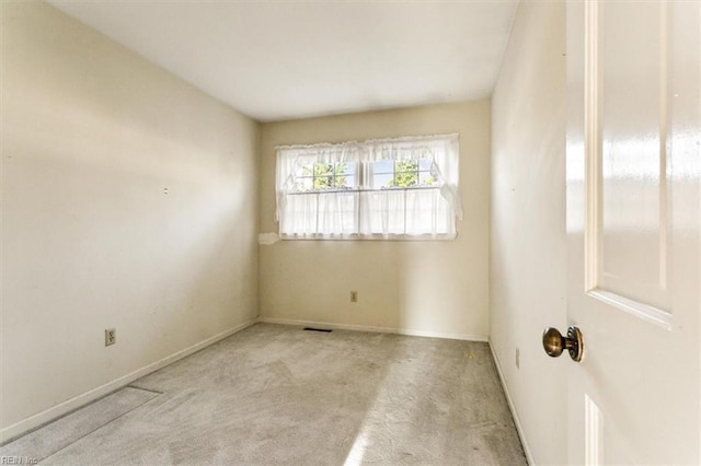 unfurnished room featuring carpet flooring, visible vents, and baseboards