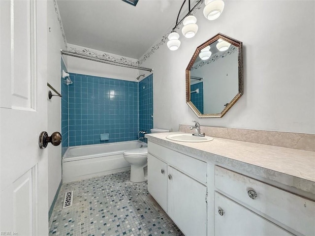 full bathroom featuring tile patterned flooring, visible vents, washtub / shower combination, toilet, and vanity