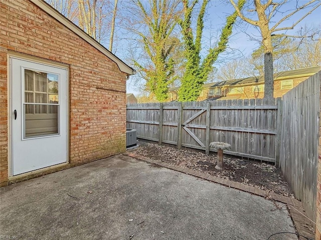 view of patio featuring central AC and fence