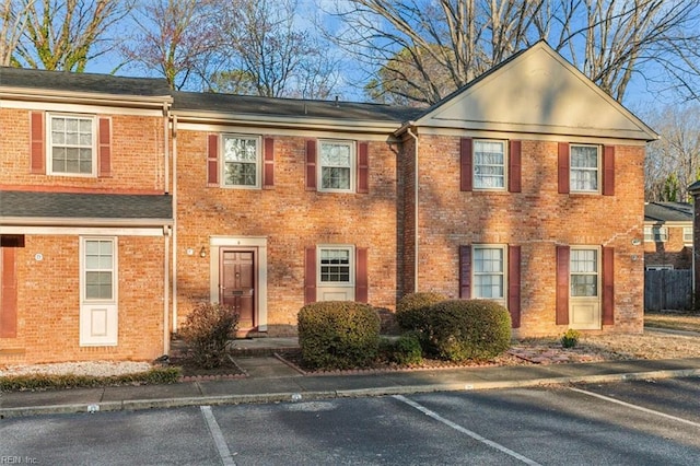 view of front of house featuring uncovered parking and brick siding