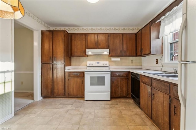 kitchen with under cabinet range hood, tasteful backsplash, white appliances, brown cabinetry, and light countertops