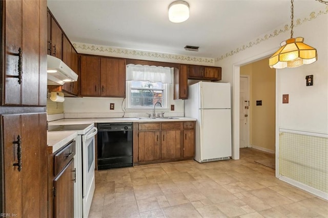 kitchen with visible vents, under cabinet range hood, light countertops, white appliances, and a sink