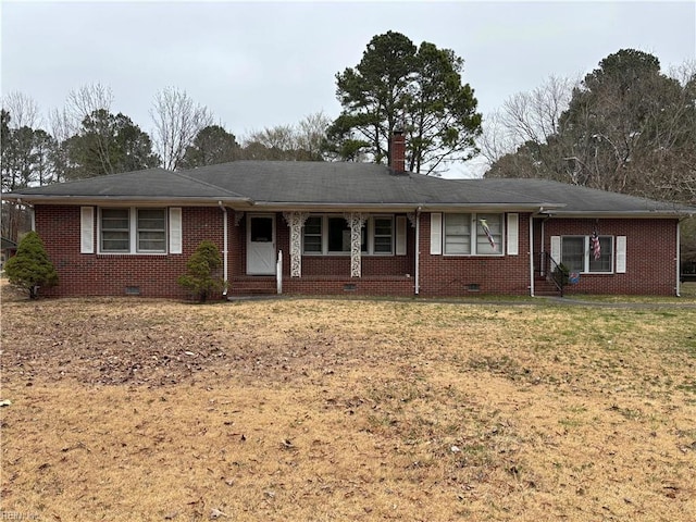 single story home with brick siding, crawl space, a chimney, and a front yard