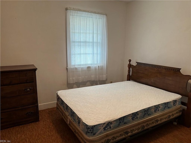 bedroom featuring carpet and baseboards