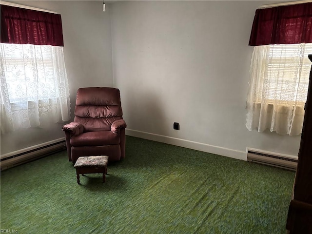 living area with carpet floors, baseboard heating, and plenty of natural light