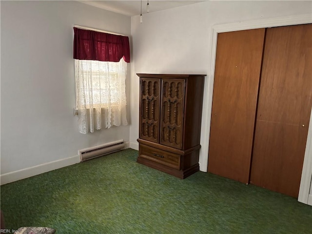 unfurnished bedroom featuring a closet, baseboard heating, baseboards, and carpet floors