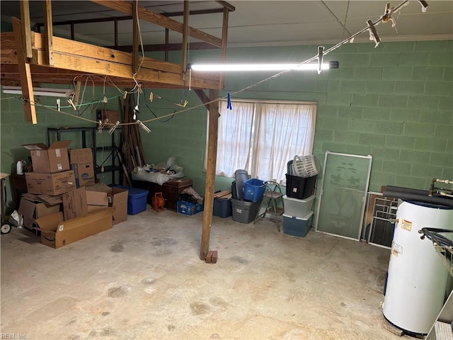 garage featuring gas water heater and concrete block wall