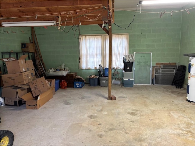 garage featuring concrete block wall and electric water heater