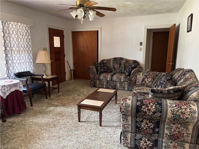 carpeted living area featuring a ceiling fan