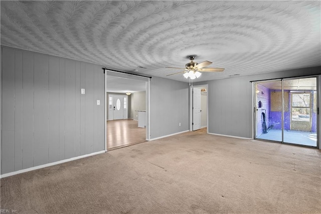 unfurnished bedroom featuring access to exterior, carpet flooring, a ceiling fan, and a textured ceiling