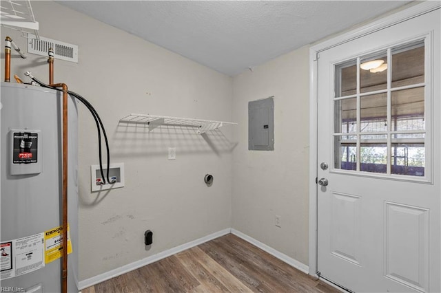 clothes washing area featuring visible vents, electric panel, water heater, hookup for a washing machine, and laundry area