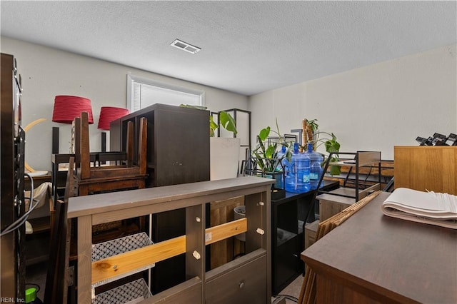 miscellaneous room with visible vents and a textured ceiling