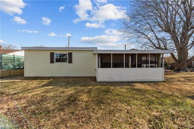 view of front of home with a front lawn and a sunroom