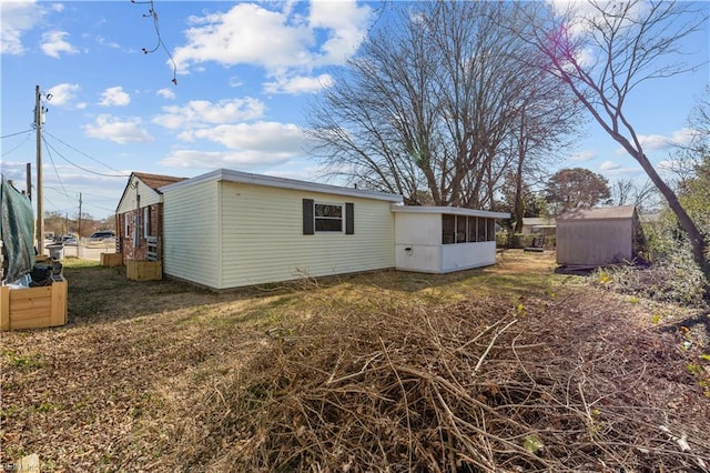 rear view of house with an outdoor structure