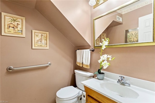 bathroom with visible vents, toilet, and vanity