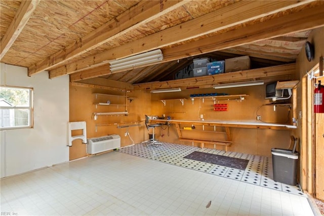 misc room with vaulted ceiling with beams and a wall mounted air conditioner